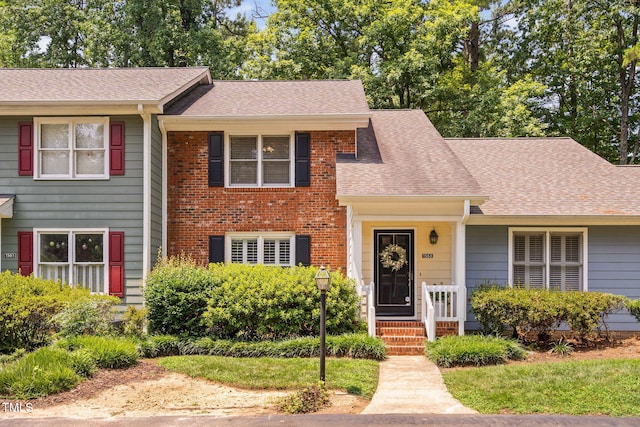 1563 Laureldale Dr, Raleigh, NC 27609 - view of front facade featuring a shingled roof and a porch
