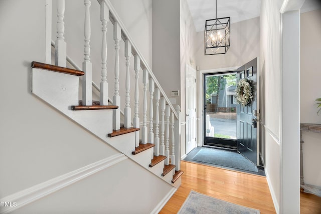 1563 Laureldale Dr, Raleigh, NC 27609 - entryway featuring stairs, wood finished floors, a chandelier, and a high ceiling