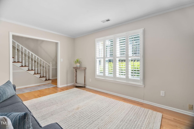 1563 Laureldale Dr, Raleigh, NC 27609 - living room featuring wood finished floors, crown molding, and stairs