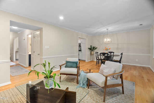 1563 Laureldale Dr, Raleigh, NC 27609 - living room featuring light wood-style floors, ornamental molding, a chandelier, and recessed lighting