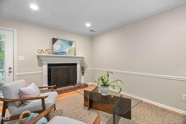 1563 Laureldale Dr, Raleigh, NC 27609 - living area featuring wood finished floors, recessed lighting, ornamental molding, and a fireplace