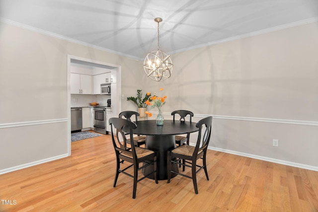 1563 Laureldale Dr, Raleigh, NC 27609 - dining space with light wood finished floors, crown molding, and a chandelier