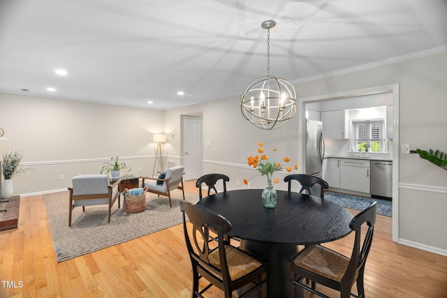 1563 Laureldale Dr, Raleigh, NC 27609 - dining space featuring a chandelier, light wood-style flooring, ornamental molding, and recessed lighting