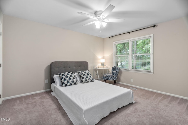 1563 Laureldale Dr, Raleigh, NC 27609 - carpeted bedroom with baseboards and a ceiling fan