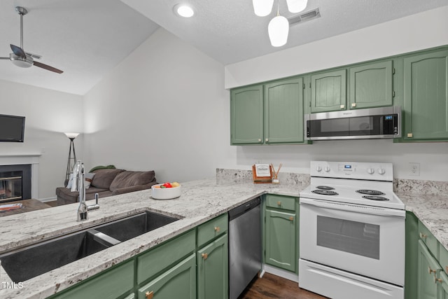 11 Stone Village Ct, Durham, NC 27704 - kitchen featuring stainless steel appliances, a ceiling fan, open floor plan, dark wood-style floors, and light stone countertops
