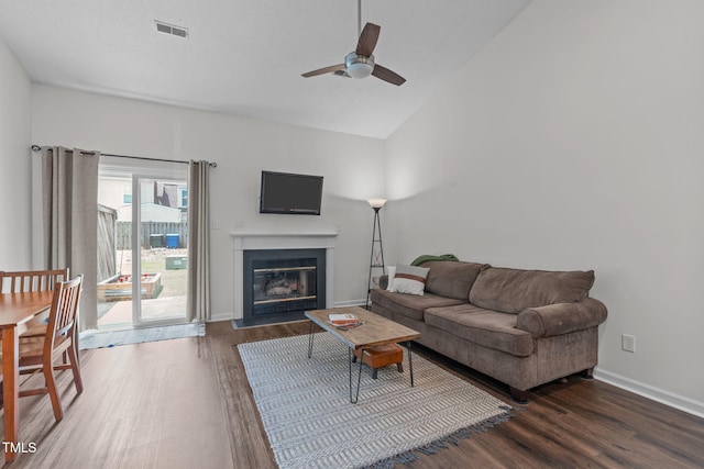 11 Stone Village Ct, Durham, NC 27704 - living area featuring wood finished floors, a ceiling fan, a glass covered fireplace, and vaulted ceiling