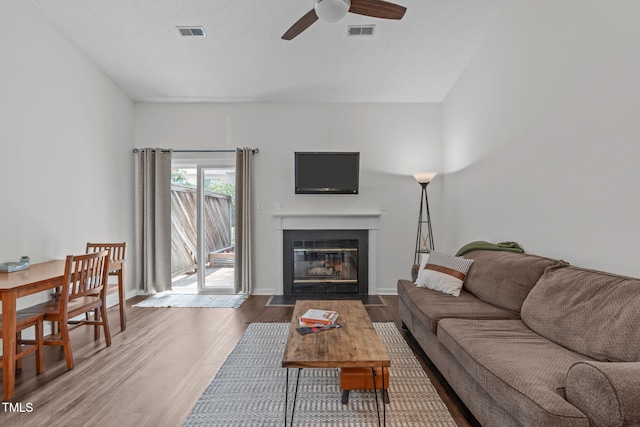 11 Stone Village Ct, Durham, NC 27704 - living room with ceiling fan, wood finished floors, and a fireplace with flush hearth