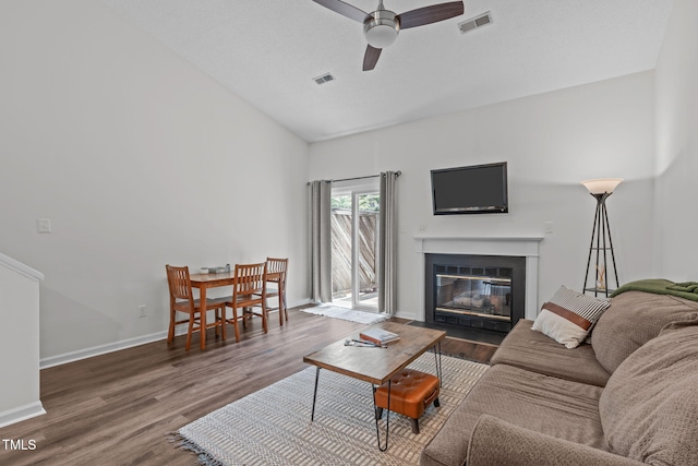 11 Stone Village Ct, Durham, NC 27704 - living room with a ceiling fan, a fireplace with flush hearth, wood finished floors, and high vaulted ceiling