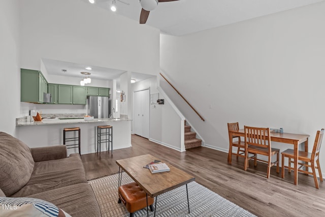 11 Stone Village Ct, Durham, NC 27704 - living area featuring stairs, wood finished floors, a towering ceiling, and ceiling fan