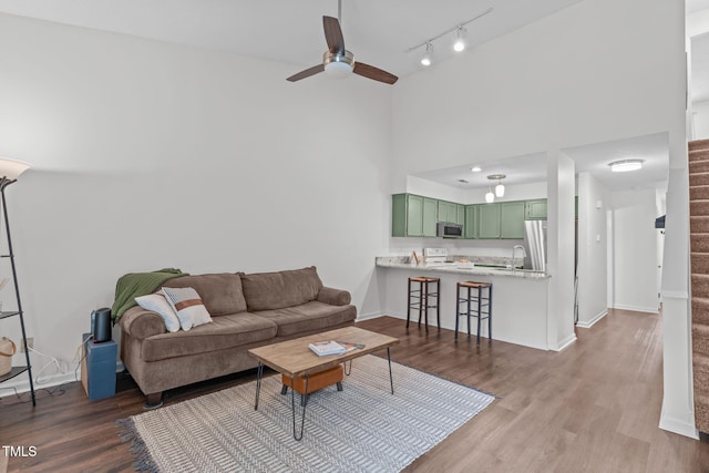 11 Stone Village Ct, Durham, NC 27704 - living area with ceiling fan, dark wood finished floors, stairs, track lighting, and a high ceiling