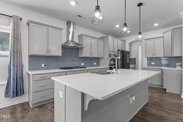 1414 Arena Ln, Fuquay Varina, NC 27526 - kitchen featuring wall chimney range hood, gray cabinets, freestanding refrigerator, backsplash, and recessed lighting