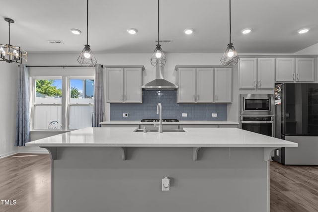 1414 Arena Ln, Fuquay Varina, NC 27526 - kitchen featuring stainless steel appliances, a kitchen breakfast bar, light countertops, and recessed lighting