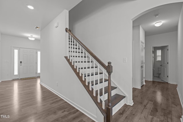 1414 Arena Ln, Fuquay Varina, NC 27526 - entrance foyer featuring arched walkways, wood finished floors, and stairway