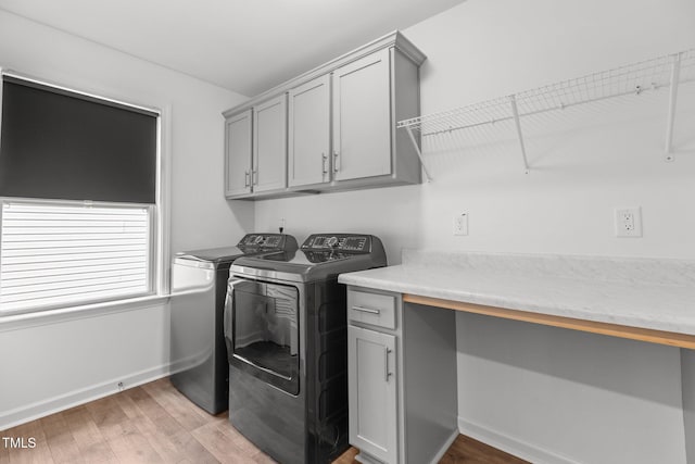 1414 Arena Ln, Fuquay Varina, NC 27526 - laundry room featuring washing machine and clothes dryer, cabinet space, and light wood-style floors