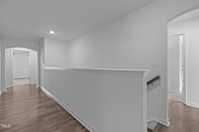 1414 Arena Ln, Fuquay Varina, NC 27526 - hall with arched walkways, an upstairs landing, and wood finished floors