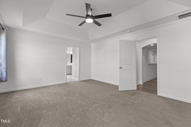 1414 Arena Ln, Fuquay Varina, NC 27526 - carpeted spare room featuring a tray ceiling, a ceiling fan, arched walkways, and a smoke detector
