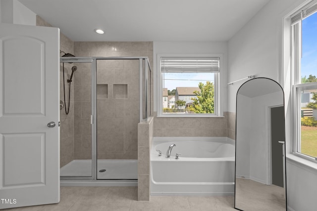 1414 Arena Ln, Fuquay Varina, NC 27526 - full bathroom with a garden tub, a shower stall, tile patterned flooring, and plenty of natural light