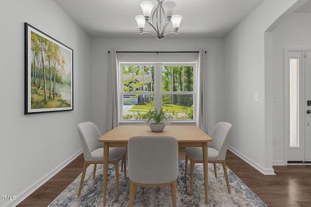 1414 Arena Ln, Fuquay Varina, NC 27526 - dining space with arched walkways, a chandelier, and dark wood-type flooring