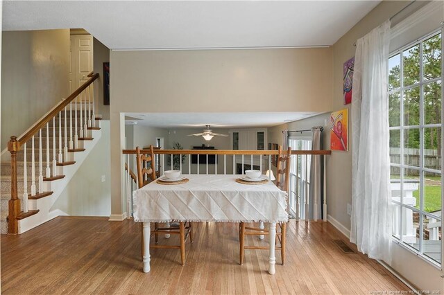 104 Somerset Dr, Raeford, NC 28376 - dining space with hardwood / wood-style flooring, ceiling fan, and stairs