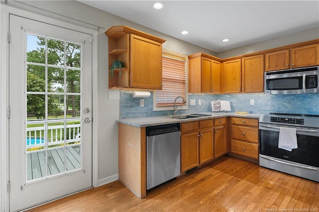 104 Somerset Dr, Raeford, NC 28376 - kitchen with stainless steel appliances, light wood-type flooring, decorative backsplash, open shelves, and recessed lighting