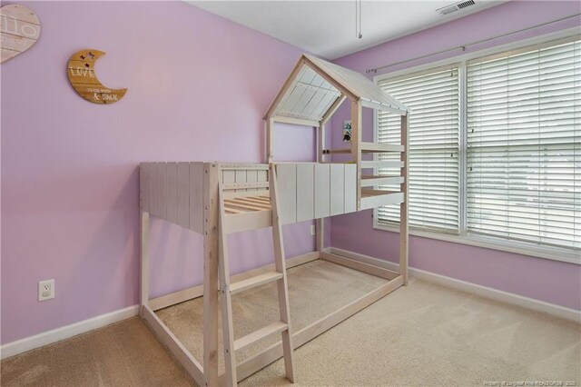 104 Somerset Dr, Raeford, NC 28376 - unfurnished bedroom featuring carpet and multiple windows