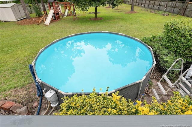 104 Somerset Dr, Raeford, NC 28376 - view of swimming pool with a playground and a storage unit