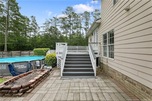 104 Somerset Dr, Raeford, NC 28376 - view of patio featuring a deck, stairs, and view of wooded area