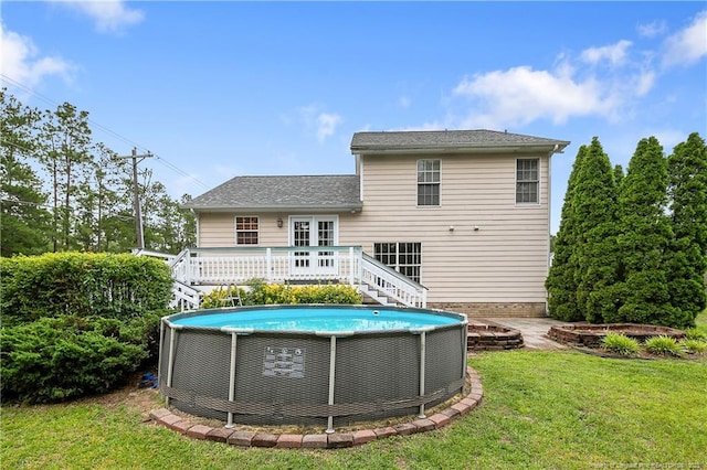104 Somerset Dr, Raeford, NC 28376 - back of property with a wooden deck, a lawn, stairway, an outdoor pool, and roof with shingles