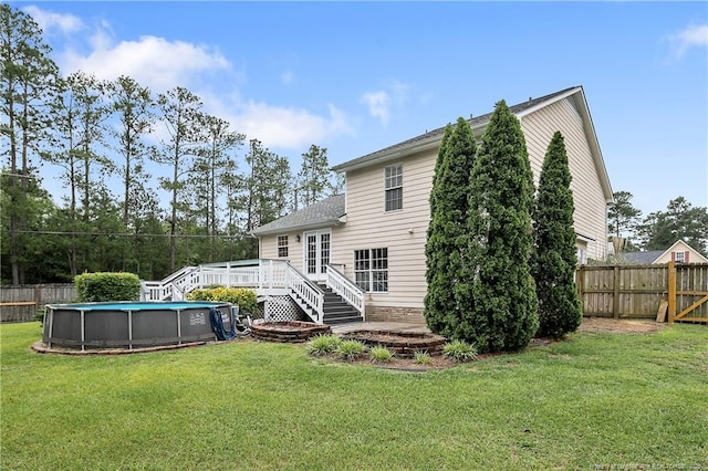 104 Somerset Dr, Raeford, NC 28376 - rear view of property featuring a deck, a fenced backyard, and roof with shingles