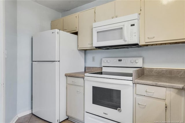329 Whipple Tree Ln, Fayetteville, NC 28314 - kitchen with white appliances, cream cabinetry, and light tile patterned floors