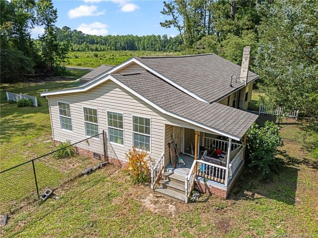 944 Cain Rd, Saint Pauls, NC 28384 - view of front of property with crawl space, a shingled roof, a chimney, and a wooded view