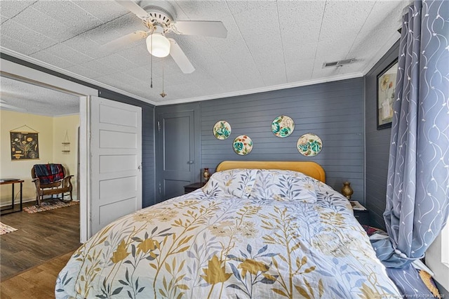 944 Cain Rd, Saint Pauls, NC 28384 - bedroom with wood finished floors, crown molding, and ceiling fan