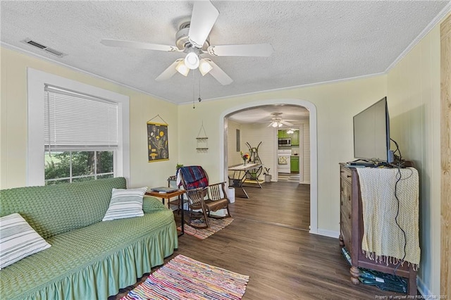 944 Cain Rd, Saint Pauls, NC 28384 - living area featuring ceiling fan, ornamental molding, arched walkways, a textured ceiling, and wood finished floors