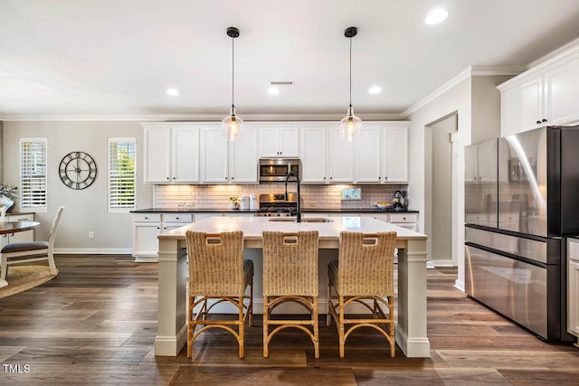 42 Juneberry Dr, Chapel Hill, NC 27516 - kitchen with stainless steel appliances, crown molding, decorative backsplash, an island with sink, and pendant lighting