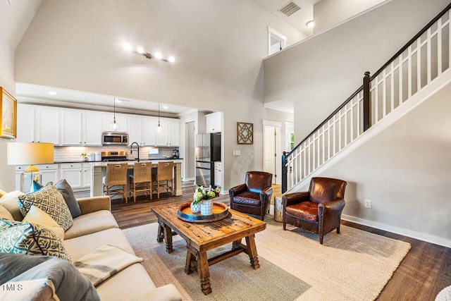 42 Juneberry Dr, Chapel Hill, NC 27516 - living area with dark wood-style floors, stairs, a high ceiling, and recessed lighting