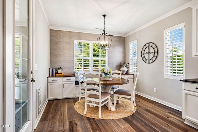 42 Juneberry Dr, Chapel Hill, NC 27516 - dining space with dark wood-style flooring, an accent wall, a chandelier, wallpapered walls, and crown molding