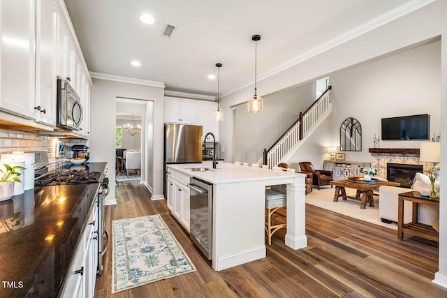42 Juneberry Dr, Chapel Hill, NC 27516 - kitchen featuring stainless steel appliances, a kitchen breakfast bar, open floor plan, white cabinets, and dark wood finished floors