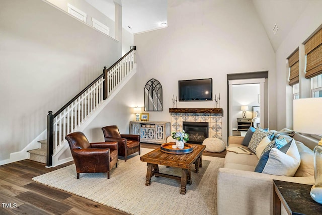 42 Juneberry Dr, Chapel Hill, NC 27516 - living area with high vaulted ceiling, wood finished floors, stairway, and a fireplace