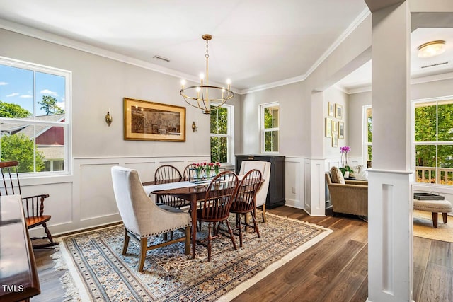 42 Juneberry Dr, Chapel Hill, NC 27516 - dining space with a chandelier, a decorative wall, dark wood-style floors, crown molding, and a wainscoted wall