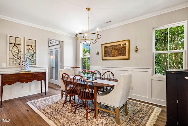 42 Juneberry Dr, Chapel Hill, NC 27516 - dining room with a decorative wall, a chandelier, crown molding, dark wood finished floors, and a wainscoted wall