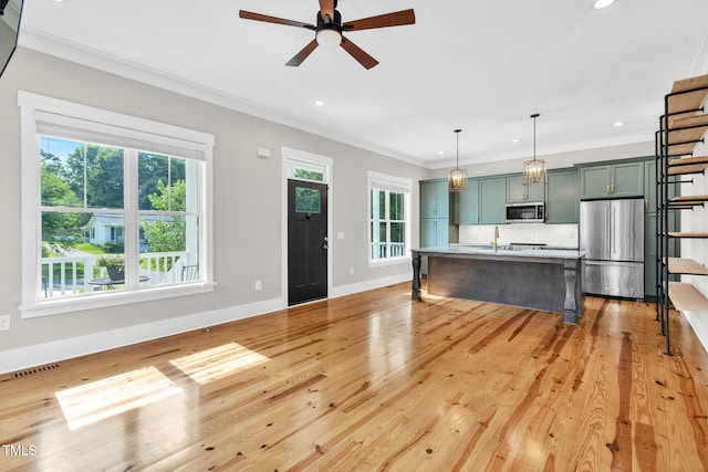 5107 Overhill St, Raleigh, NC 27603 - kitchen featuring appliances with stainless steel finishes, crown molding, ceiling fan, light countertops, and decorative backsplash