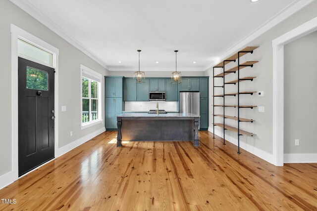 5107 Overhill St, Raleigh, NC 27603 - kitchen with stainless steel appliances, a kitchen island with sink, blue cabinets, light wood-style floors, and backsplash