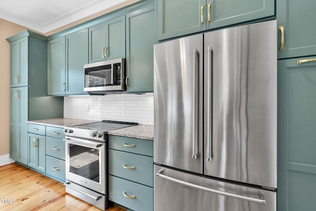 5107 Overhill St, Raleigh, NC 27603 - kitchen with stainless steel appliances, light wood finished floors, backsplash, green cabinetry, and light stone counters