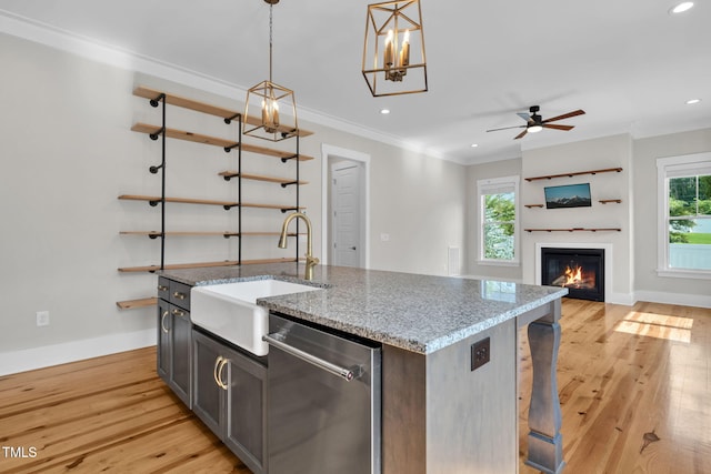 5107 Overhill St, Raleigh, NC 27603 - kitchen featuring stainless steel dishwasher, light wood-type flooring, a kitchen island with sink, ornamental molding, and recessed lighting