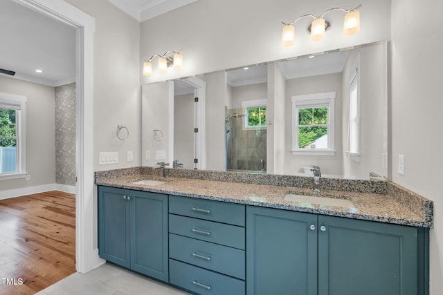 5107 Overhill St, Raleigh, NC 27603 - bathroom featuring a stall shower, double vanity, crown molding, wood finished floors, and recessed lighting