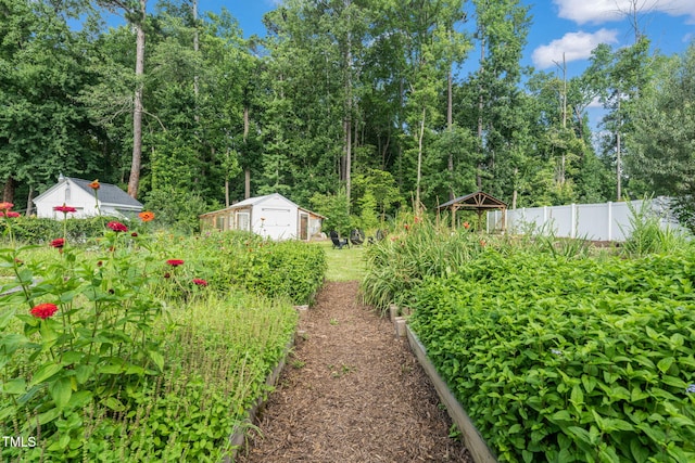 5107 Overhill St, Raleigh, NC 27603 - view of yard featuring a storage shed and a garden