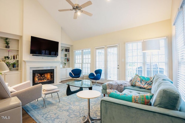 10 Marchmont Ct, Durham, NC 27705 - living room featuring high vaulted ceiling, built in shelves, wood finished floors, a fireplace, and a ceiling fan
