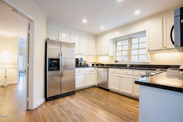 10 Marchmont Ct, Durham, NC 27705 - kitchen with stainless steel appliances, ornamental molding, light wood finished floors, white cabinetry, and recessed lighting