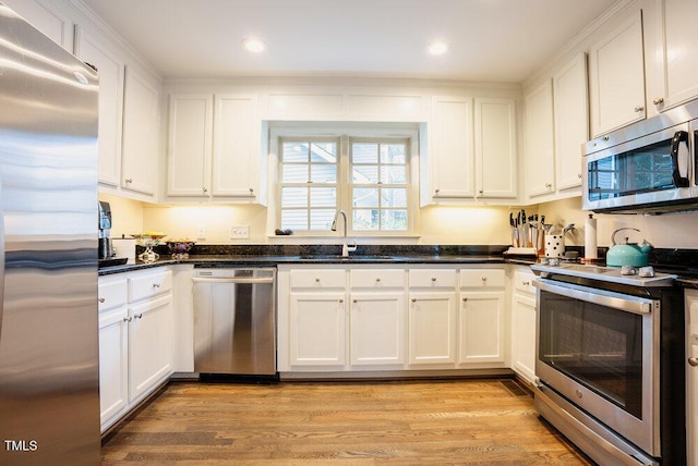 10 Marchmont Ct, Durham, NC 27705 - kitchen with stainless steel appliances, white cabinets, light wood-style flooring, and recessed lighting