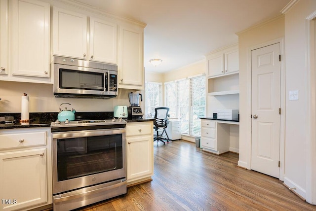 10 Marchmont Ct, Durham, NC 27705 - kitchen featuring appliances with stainless steel finishes, light wood-type flooring, built in study area, open shelves, and white cabinets